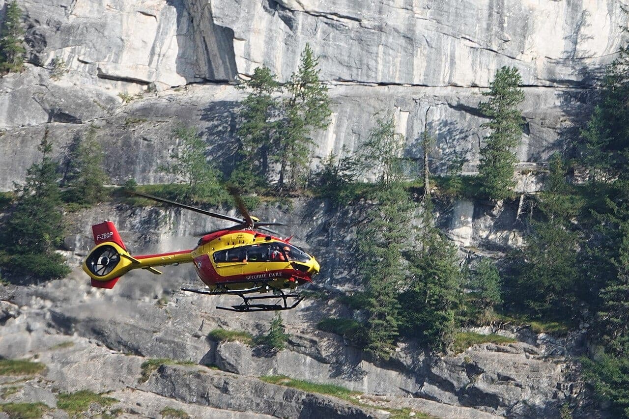 French Sécurité Civile H145 rescue helicopter flying in mountain terrain
