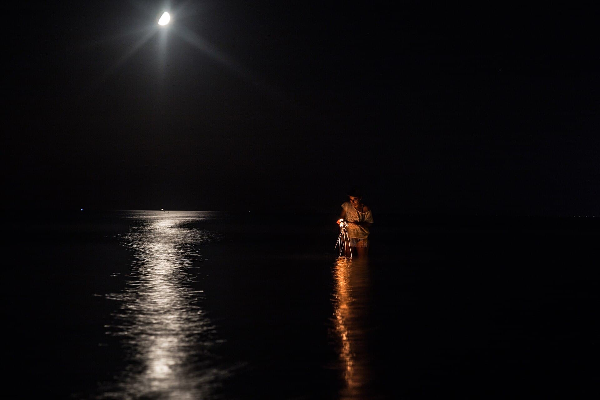 Moonlight reflected on a dark sea with most of the horizon invisible